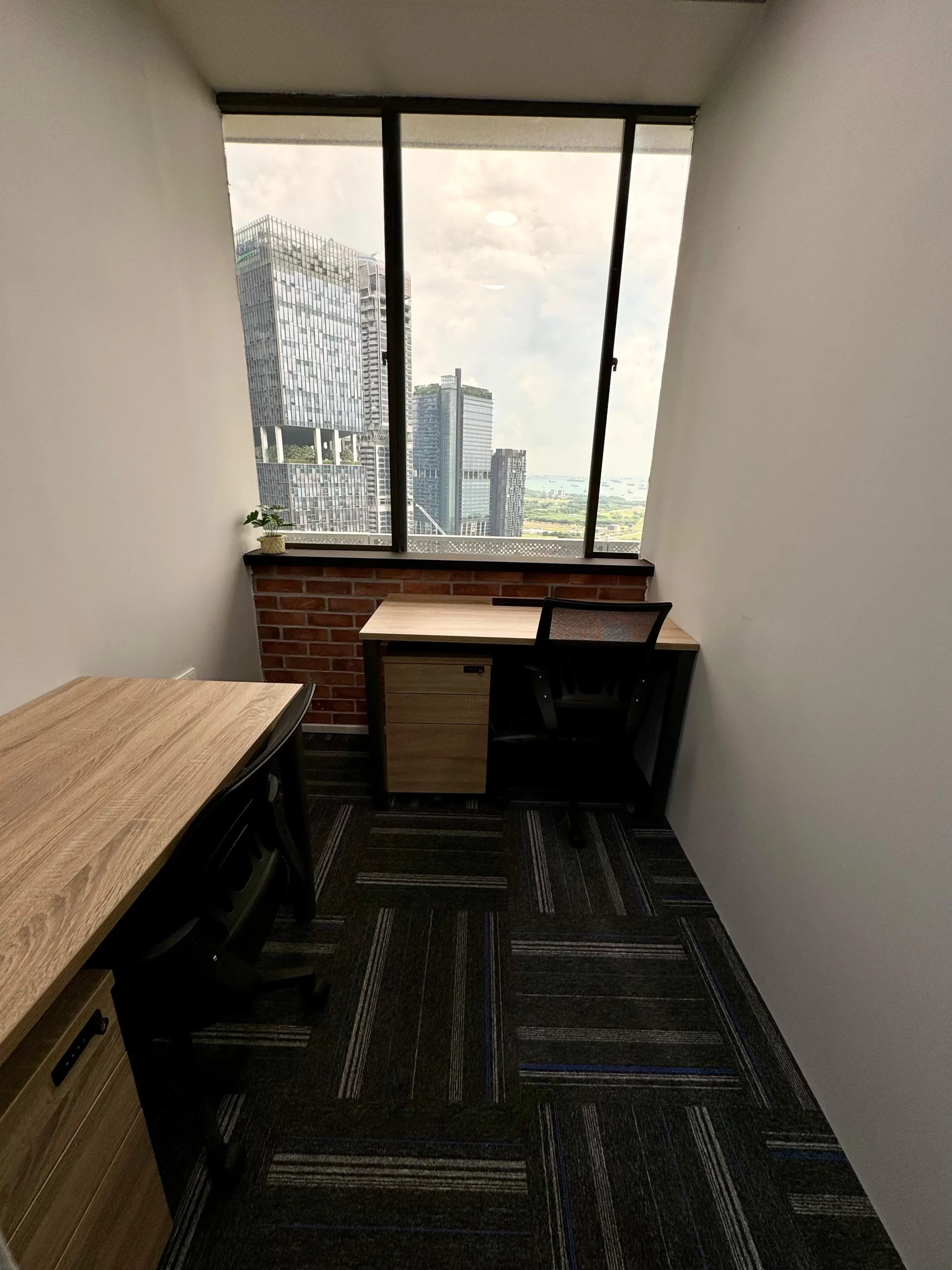 Dedicated desk in Singapore CBD, workspace with city and sea view at Penguins Coworking